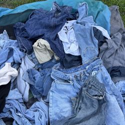 Assortment Of Jeans And Sweatpants And 2 Sleeping Bags