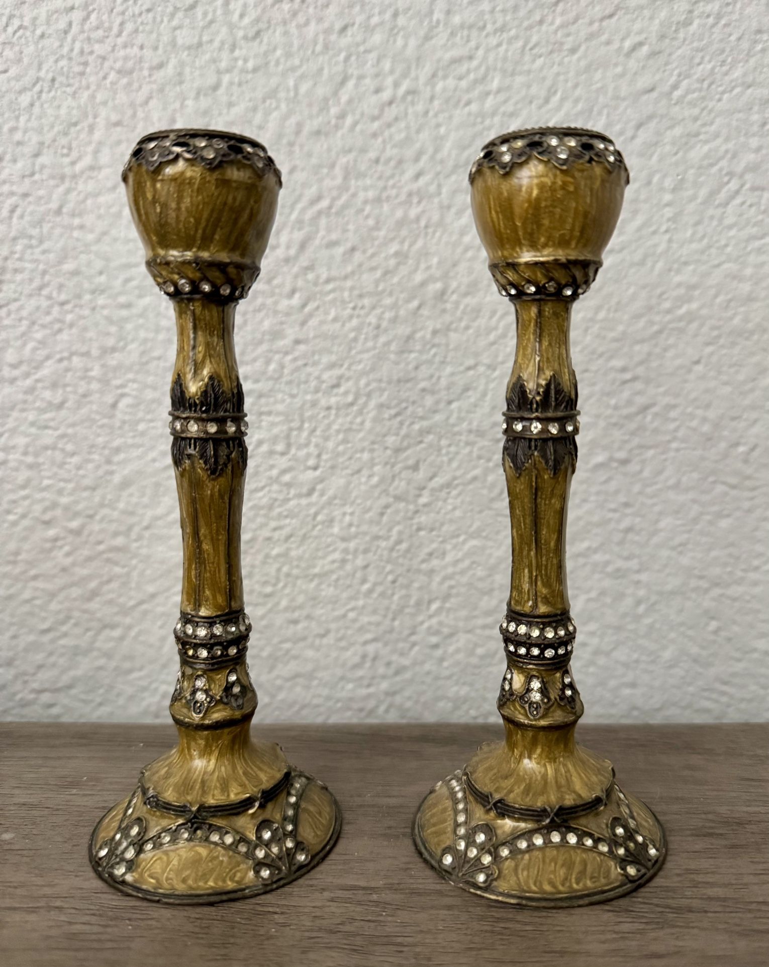 A pair of metal candle holders. 
