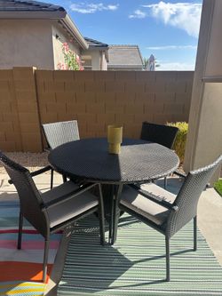 Dark woven outdoor patio furniture with Gray cushions