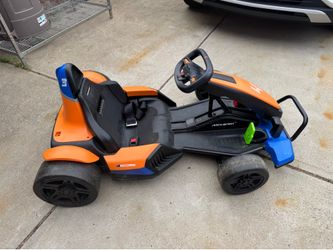 Kidzone McLaren 24V Electric Ride-On is a battery-powered go-kart featuring a branded racing seat, adjustable seatbelt, and specialized drift wheels
