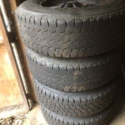 4 Tires And Spare Tire On A Steel Rim