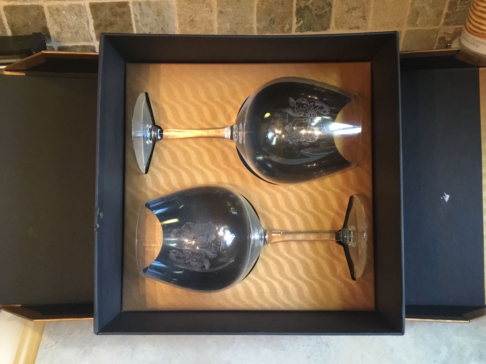 Wine glasses with toasting etchings. Perfect for weddings or other special occasions. Tucked away in a nice display case.