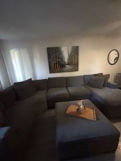 Gray sectional couch with storage ottoman