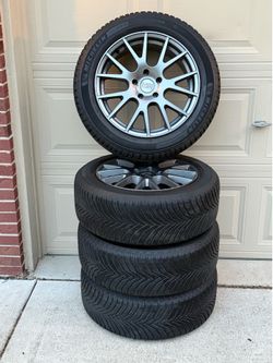 Four (4) New Michelin Cross Climate 215/55R17 Tires mounted on MB rims
