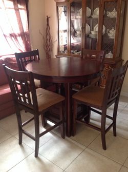 High top solid wood table with four matching clean chairs