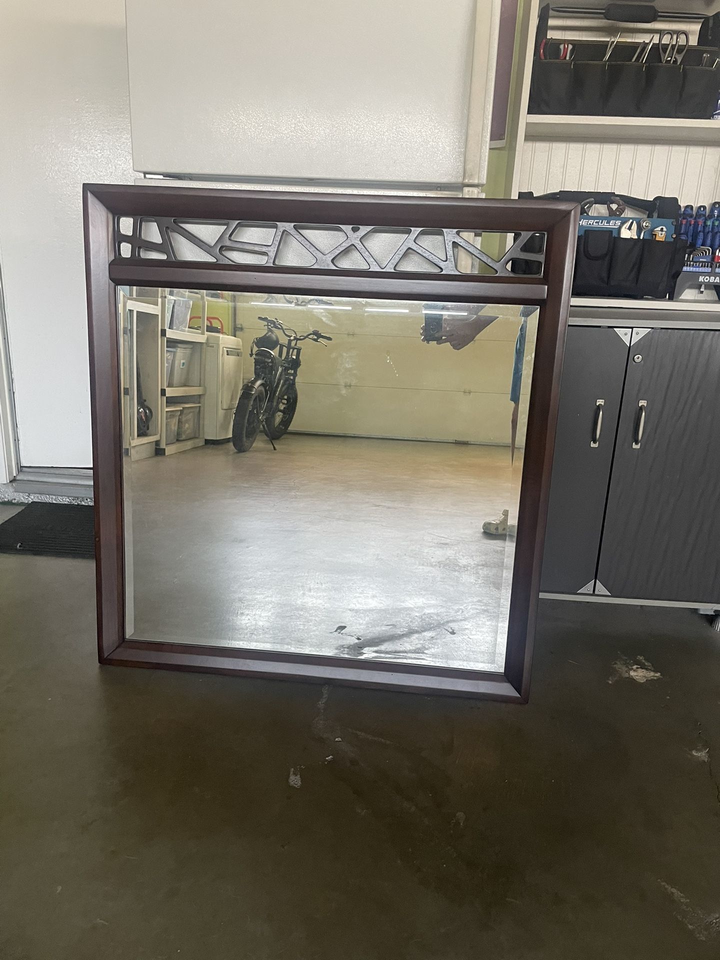LARGE FRAMED DESIGNER SOLID WOOD MIRROR. NEW. 40 INCHES WIDE AND 43 INCHES HIGH. DARK BROWN