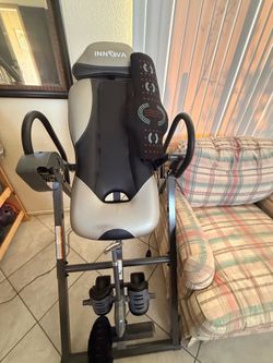 Inversion table with massage pad