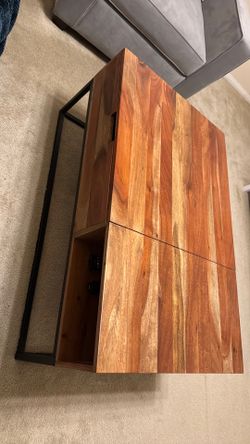 Wooden coffee table with hidden compartment