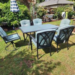 Lightweight patio table with 4 side chairs and two swivel chairs with thick cushions. Like new