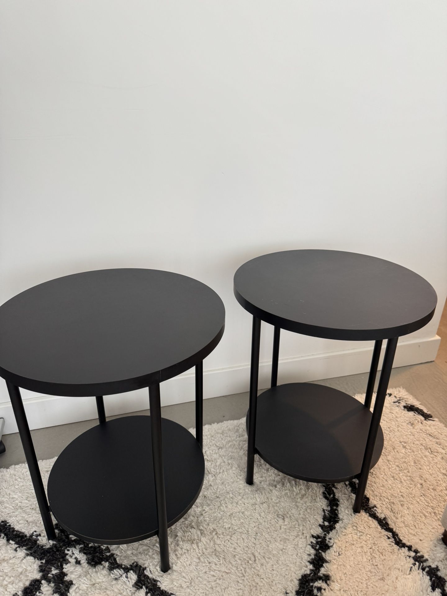 Two Round Black Tables