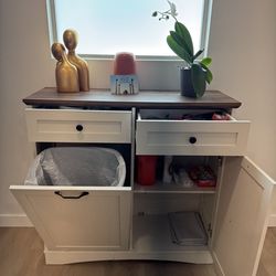 Tilt out trash cabinet with storage space