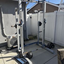 Squat rack with weights and barbell