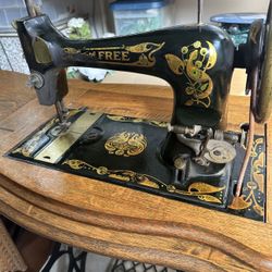 Antique Sewing Machine In Oak Cabinet