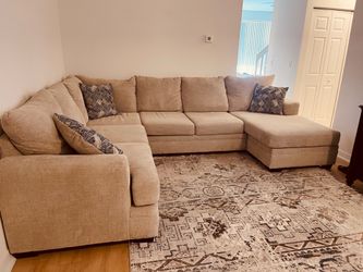 Sectional Sofa with three blue pillows