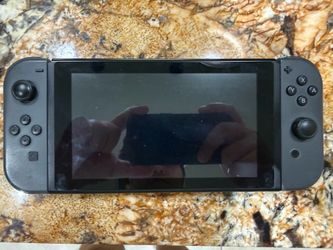 Nintendo Switch (w/ Zelda BOTW & Mario Kart 8 Deluxe)