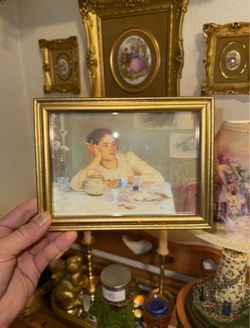 Small gold wooden picture frame of woman smoking