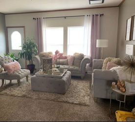 Two couches and chair, ottoman, credenza o tv stand  and chandelier