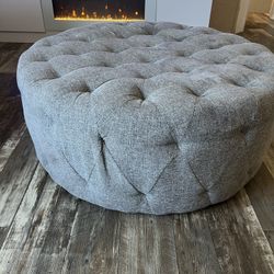 Round tufted ottoman 