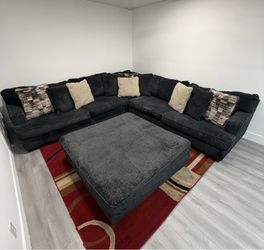 Ashley Furniture Lavernett Charcoal 4-Piece Sectional Sofa with Ottoman. Delivery available for an additional cost.