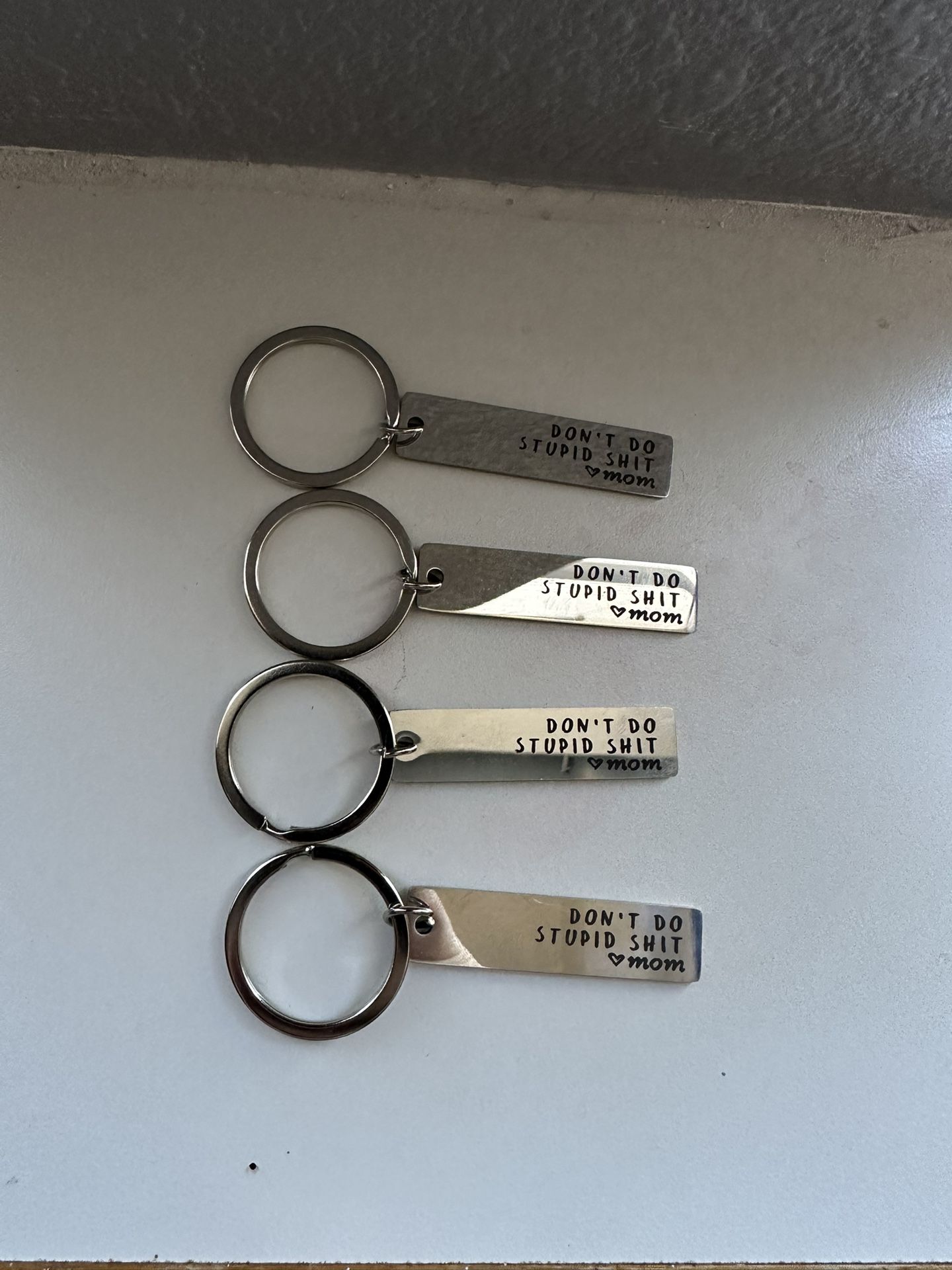 “DONT DO STUPID SH**. love mom” keychain