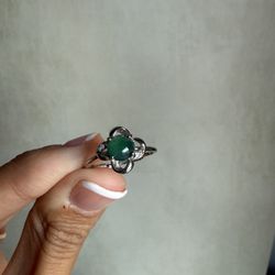  Natural Green Jade Ring in Sterling Silver Adjustable Size    Details: 	•	Center Stone: Natural Green jade 	•	Accent Stones: High-quality CZ  	•	Sett