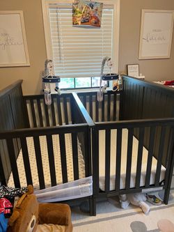 2 cribs and rocking chair with ottoman