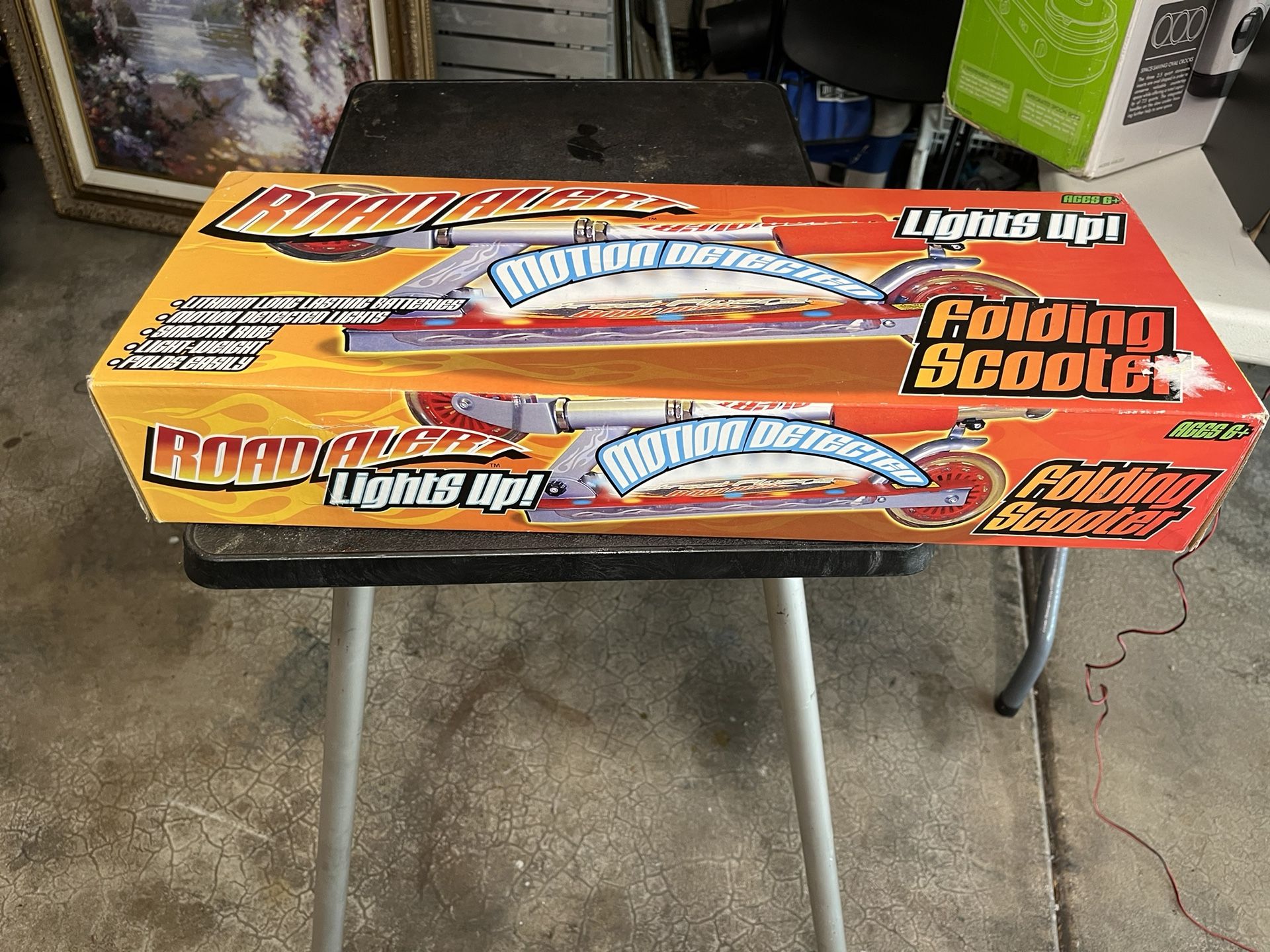 Brand new in the box Rode alert, folding scooter lights up with motion detection