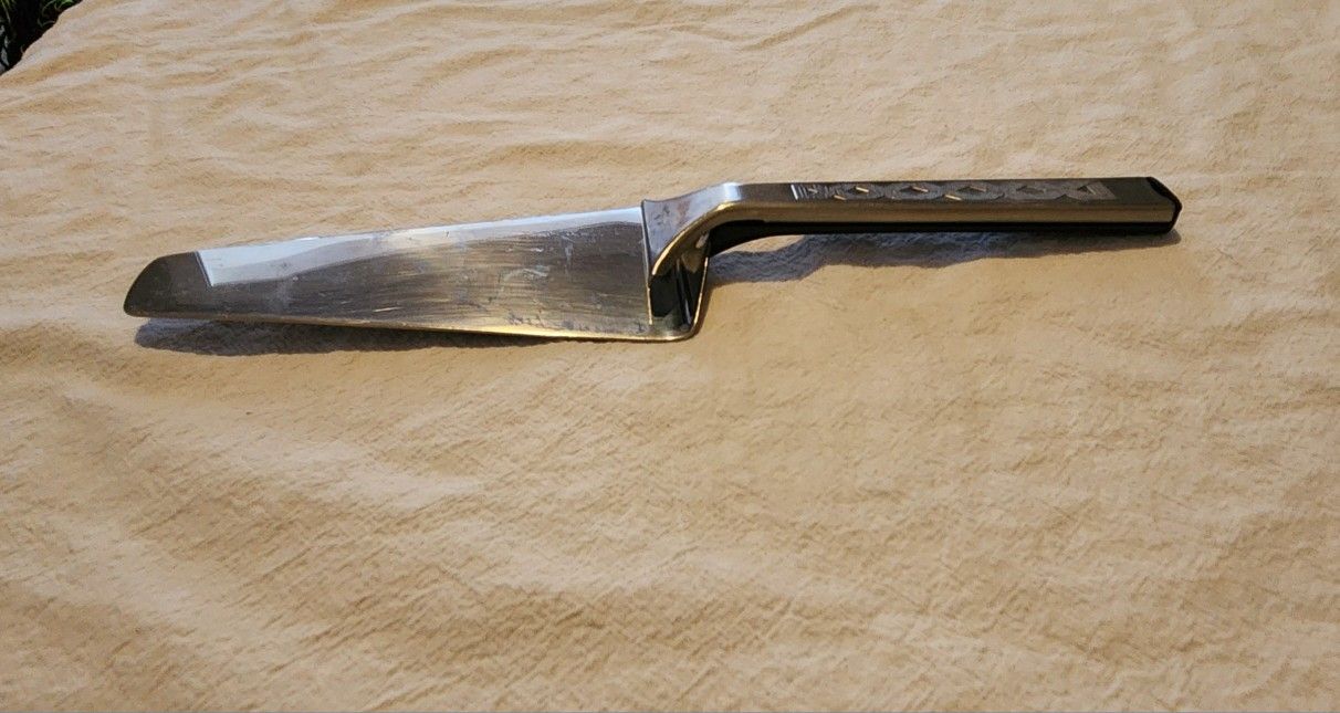 Vintage Cake or Pie Server Slicer. Pushes cake or pie onto your plate with a slide of your thumb. Stainless Steel. Piazza Effepi brand. 9.75" Long