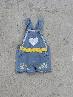 Blue denim overalls with embroidered heart, yellow ribbon, and daisy details size 3T