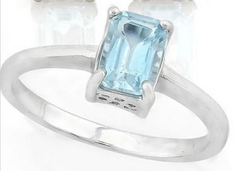 Sky blue topaz emerald cut solitaire ring in sterling silver