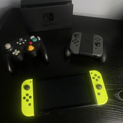 Nintendo Switch 32GB Console Black with Neon Yellow Joy Cons, includes Dock and Grip (with Grey Joy Cons) & Power A Gamecube Style Wireless Controller