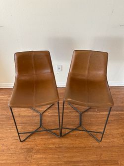 A pair of west elm leather bar stool for sale