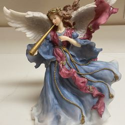 Peggy Abrams musical angel figurine in a beautiful Ethereal Blue color robe. Plays “Angels we have heard on high”. 8” tall x 8” 