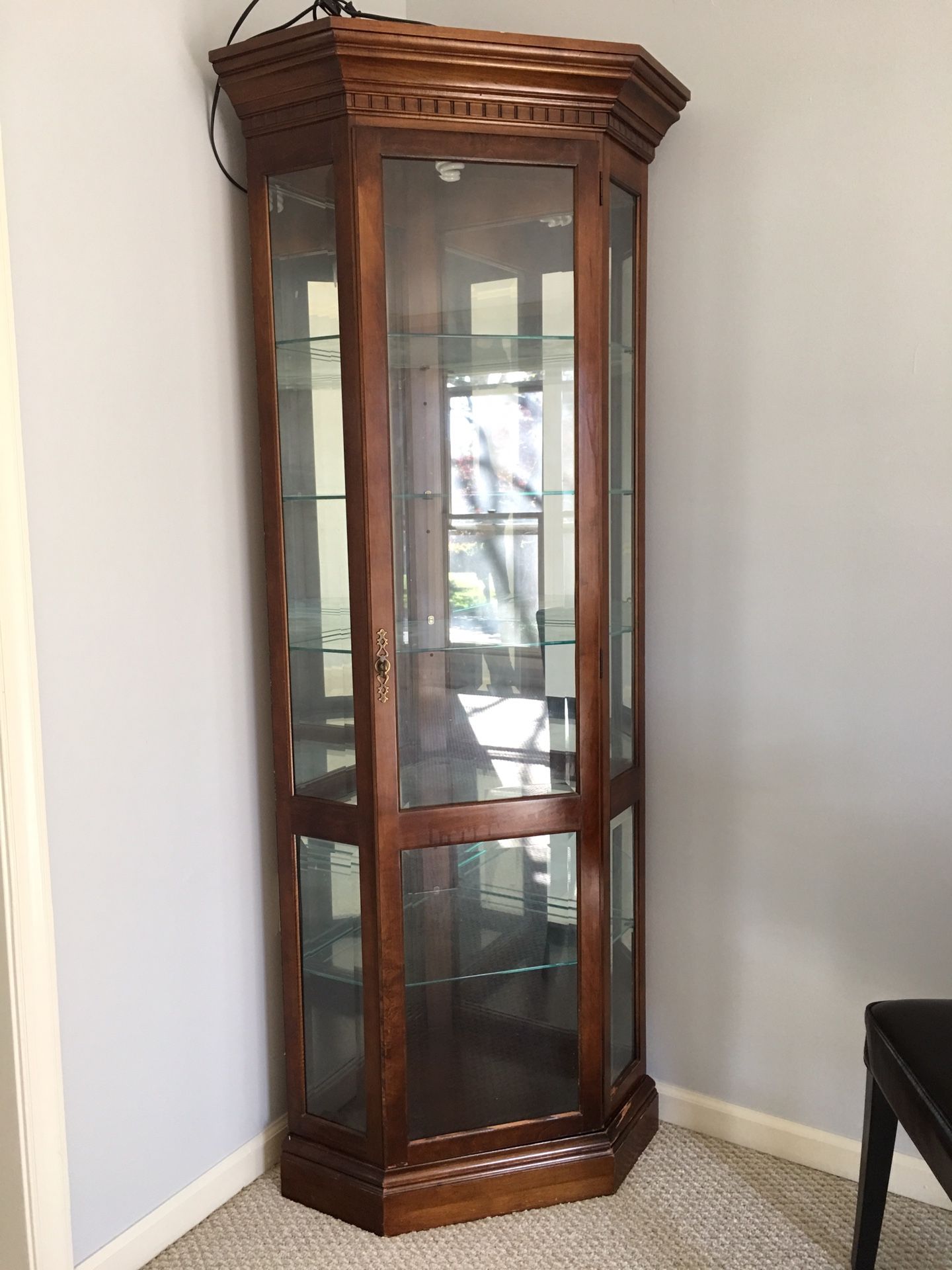 Wood corner cabinet with glass and wired lighting