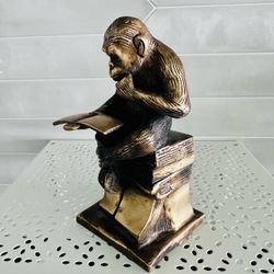 vintage Charles Darwin's Reading Monkey solid brass sculpture/ bookend.  He is heavy weighted 3 pounds.  7“Tall x 3 1/2“ across the bottom base