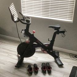 Peloton PL-01-R-B exercise bike and shoes