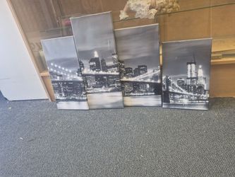 four-panel black and white canvas set features a nighttime view of the Brooklyn Bridge and New York City skyline