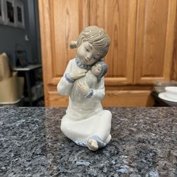 Vintage Retired Zaphir Lladro “Girl and Doll Baby” figurine.  Side approximately 6 inches tall.  Preowned excellent condition.  There are no white spo