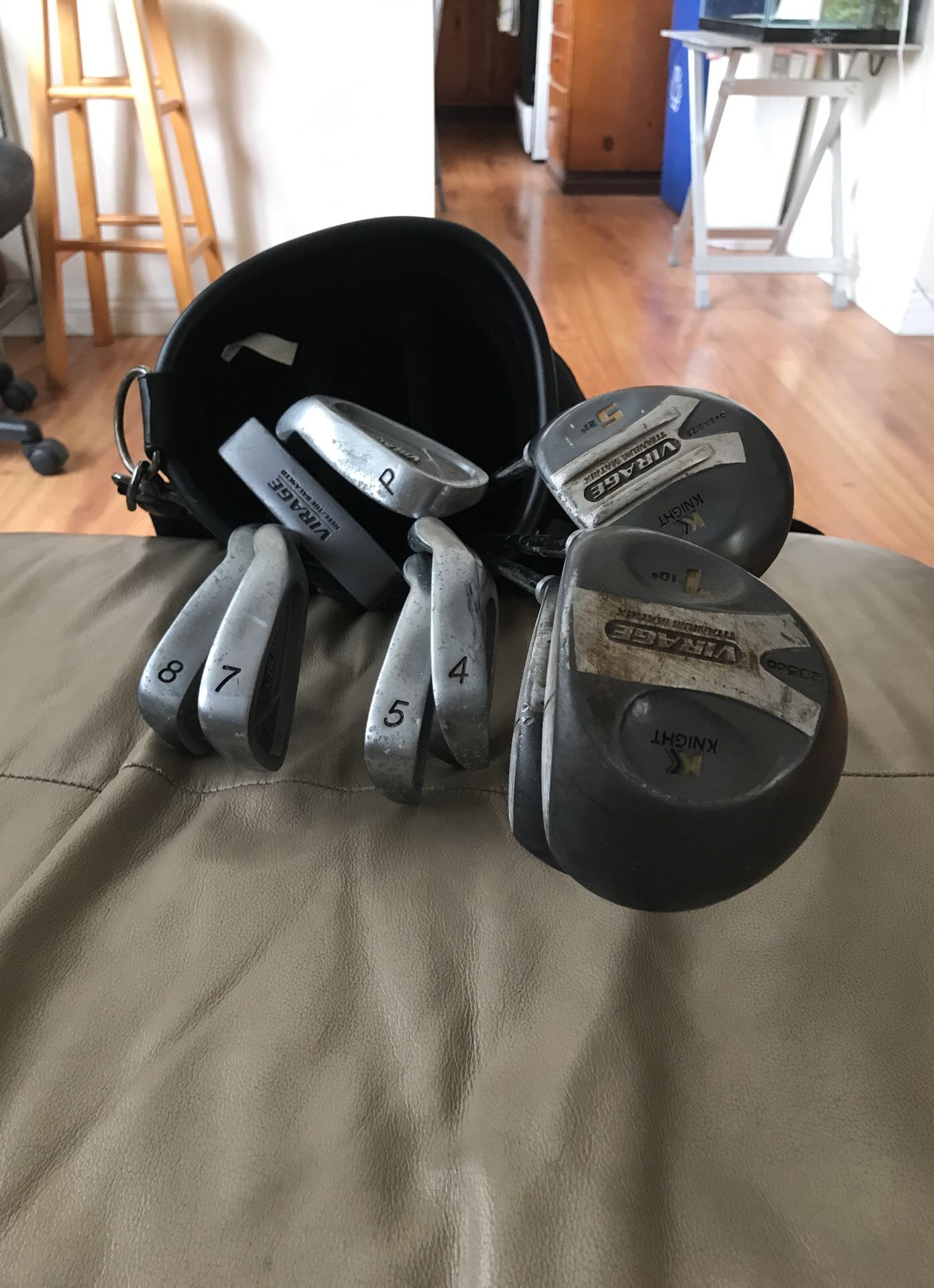Set of gently used golf clubs with bag, cover and arm strap.