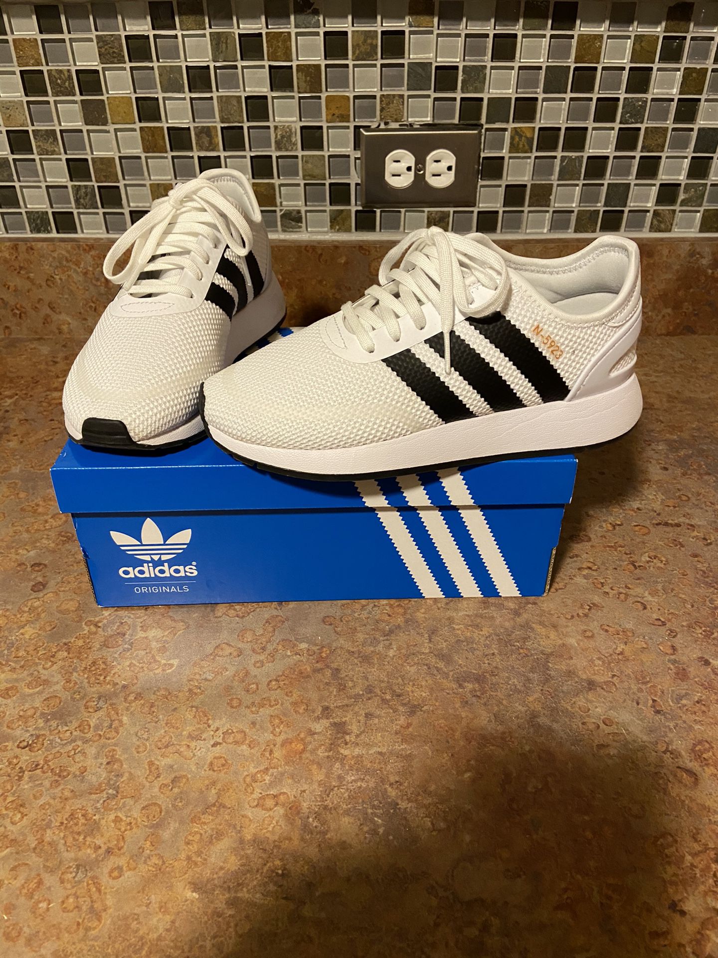 White and black adidas N5923 size 5 youth only worn once.
