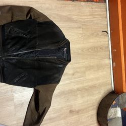 This is a vintage black and brown suede leather varsity jack
