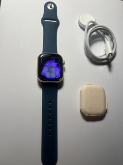 Never used Apple Watch series 10 gps + cellular 42mm rose gold with blue band S/M and charger. apple warranty