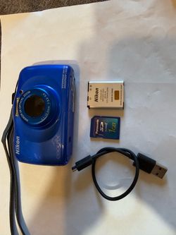 Waterproof Nikon Coolpix S33 digital camera is blue and features a Nikkor 3x optical zoom lens. This bundle includes a Nikon EN-EL19 lithium-ion batte