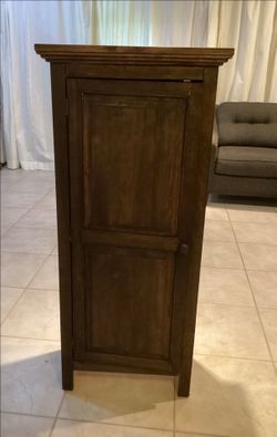 Wood storage cabinet with magnet closure.