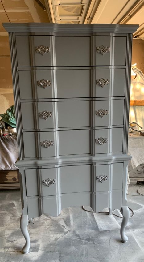 A very tall, tallboy dresser with 5 deep drawers and silver handles simply amazingly beautiful people