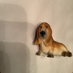 VINTAGE DOG FIGURINE. SITTING BASSET HOUND. MINT. RESIN. 4” LONG