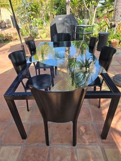 Glass dining table with 6 leather seats