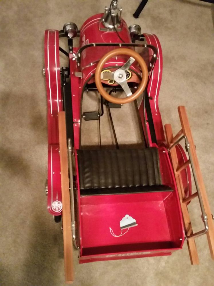 Children riding fire truck well built antique peddle car, be the dad or grandpa of the year