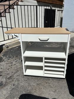 Storage cabinet with adjustable table