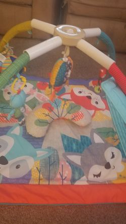 Play mat with toys and a bottle sanitizer